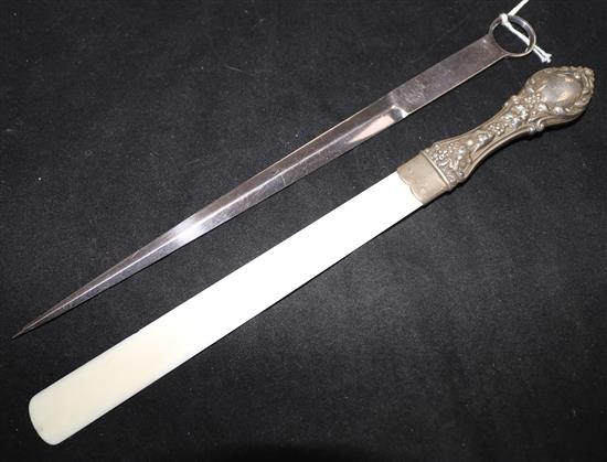A silver handled paper knife and a plated meat skewer.